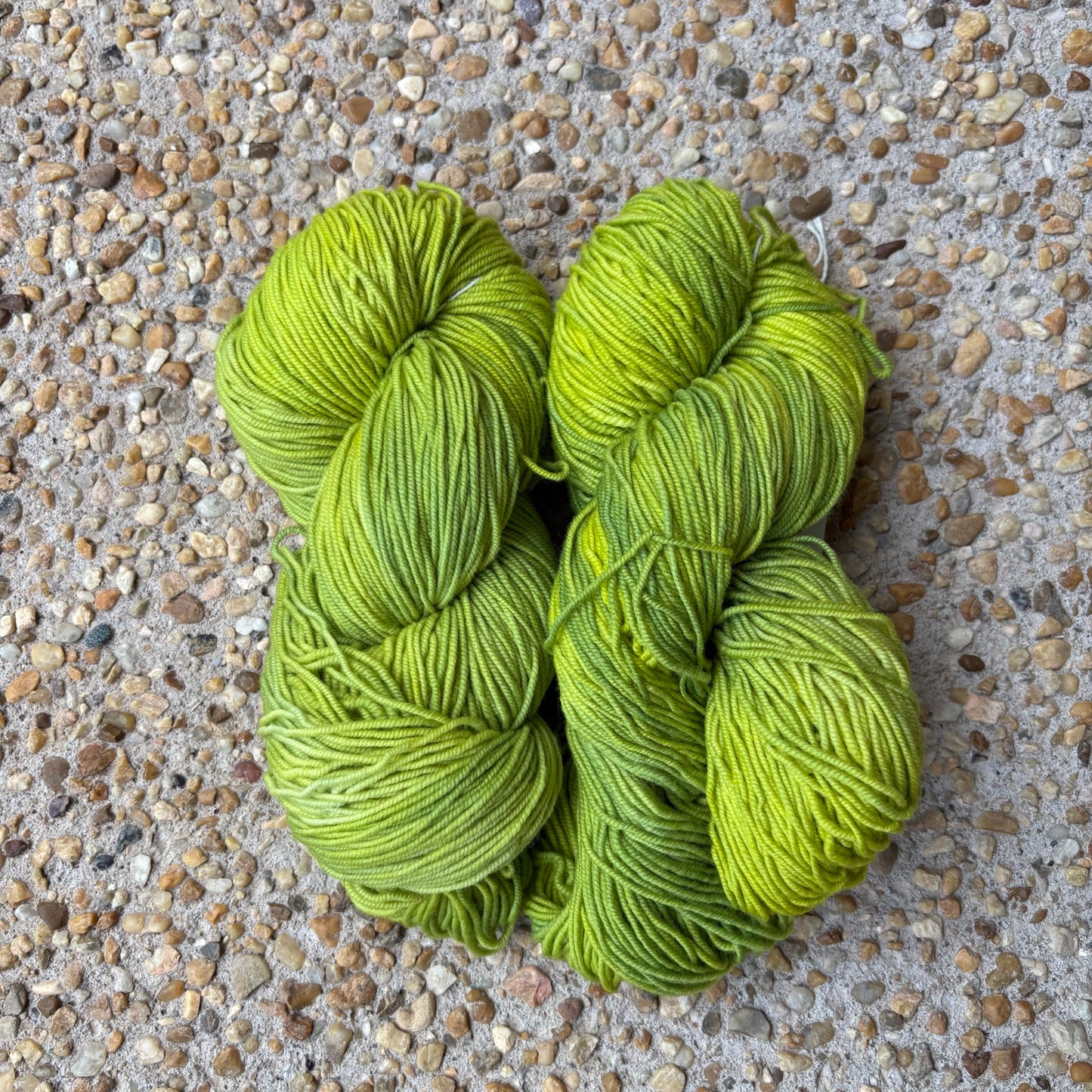 Skein of hand-dyed Atomic yarn in electric chartreuse Merino