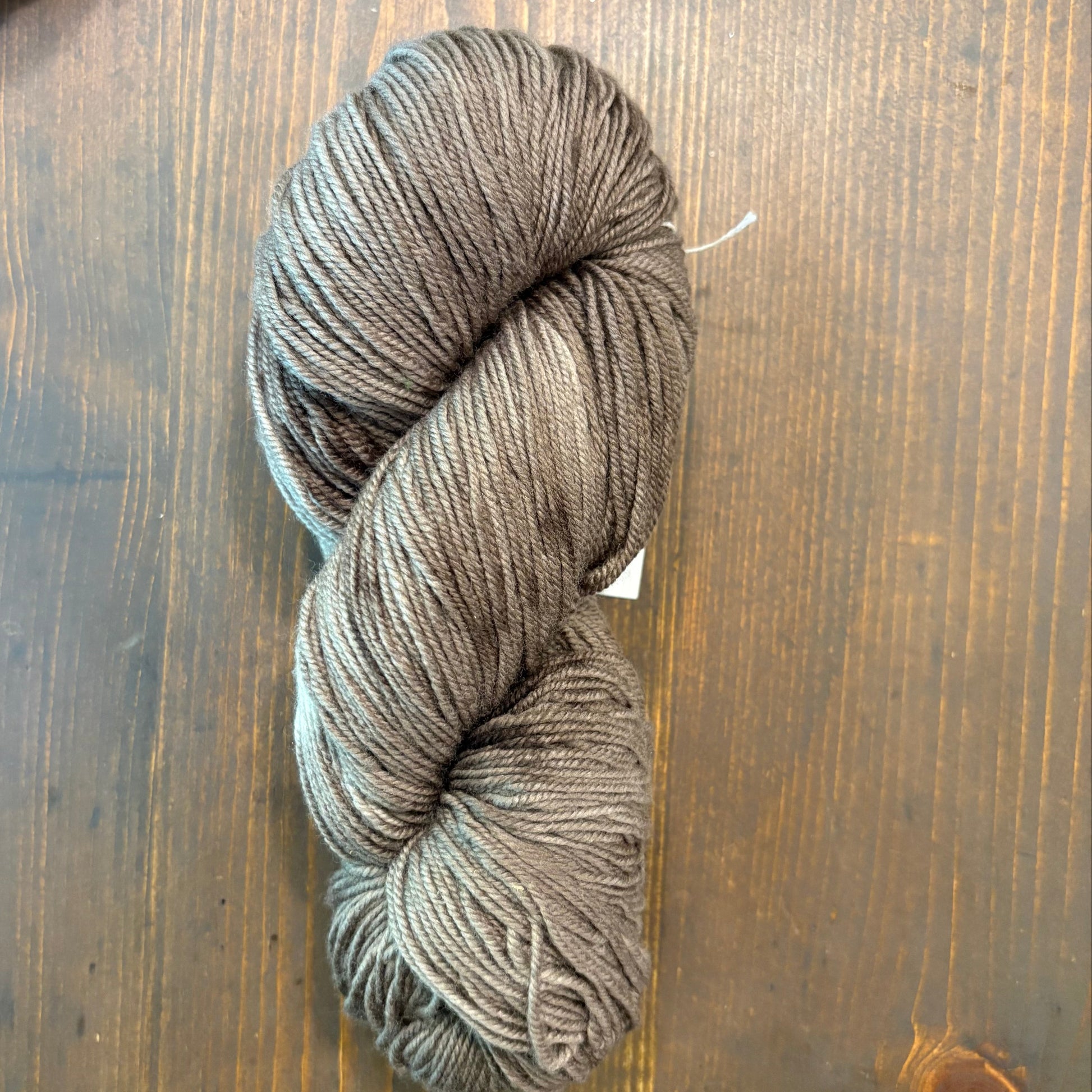 Hand dyed skein of Merino/silk blend in a brown/gray color