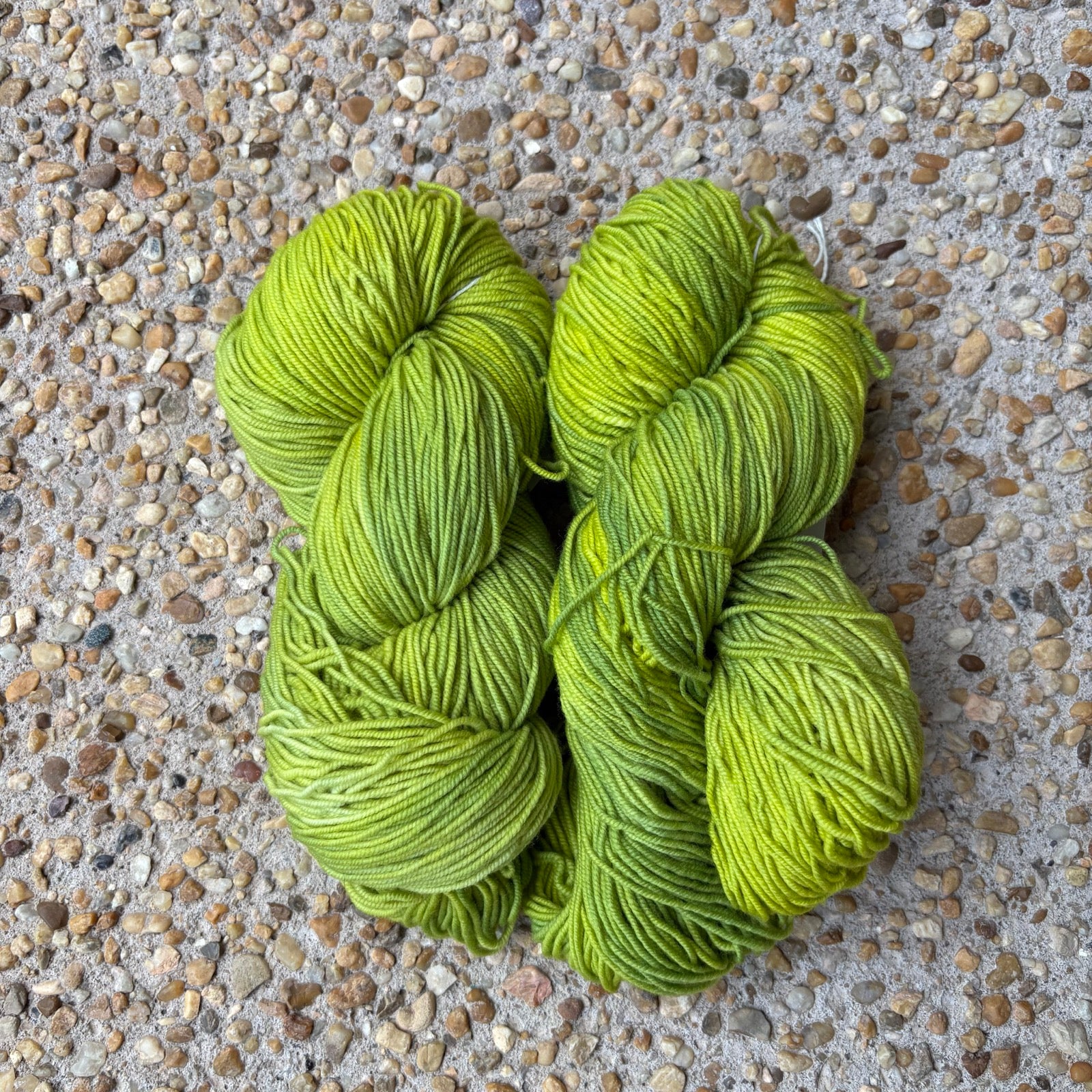 Skein of hand-dyed Atomic yarn in electric chartreuse Merino