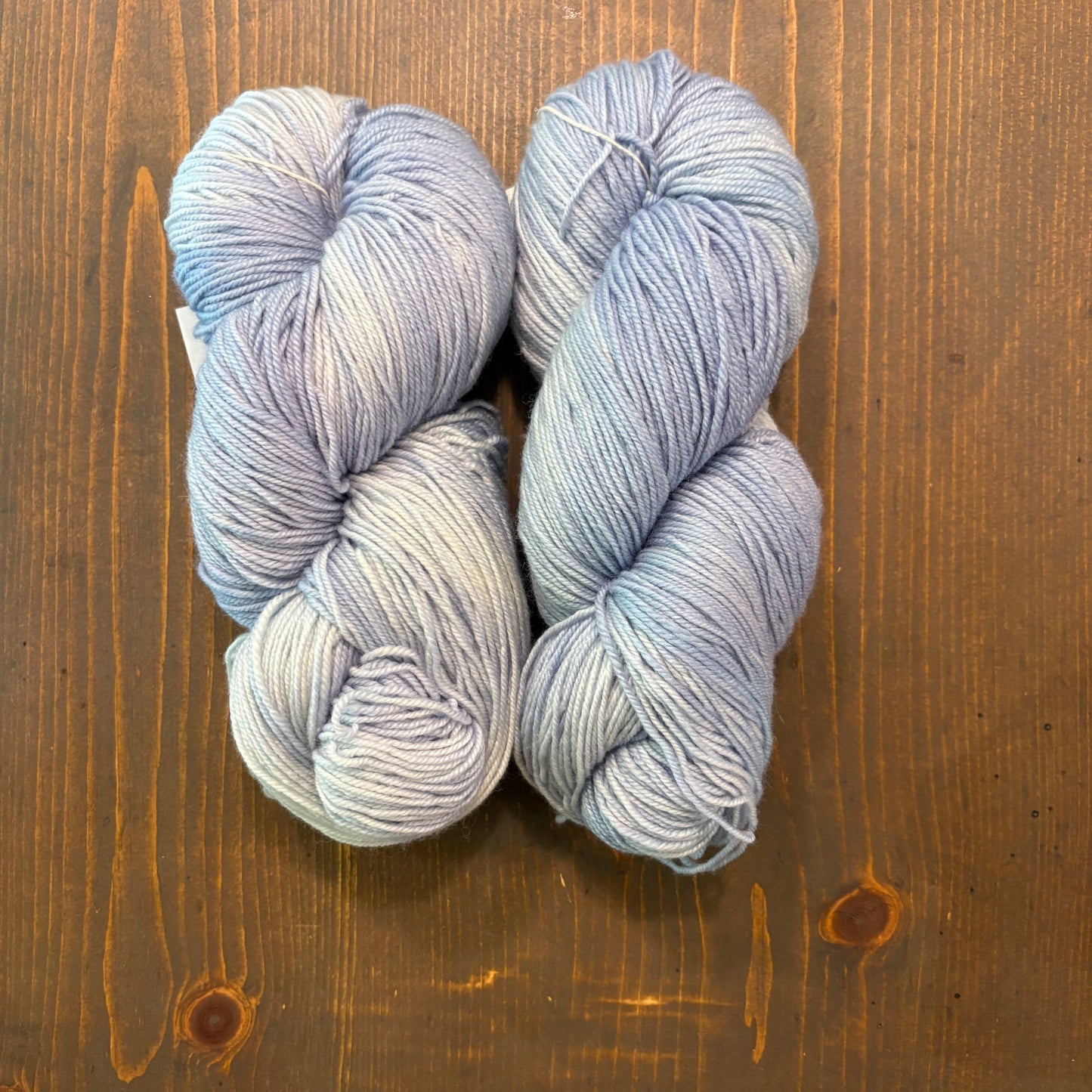 hand dyed skeins of Merino/Silk blend yarn in a light blue/violet