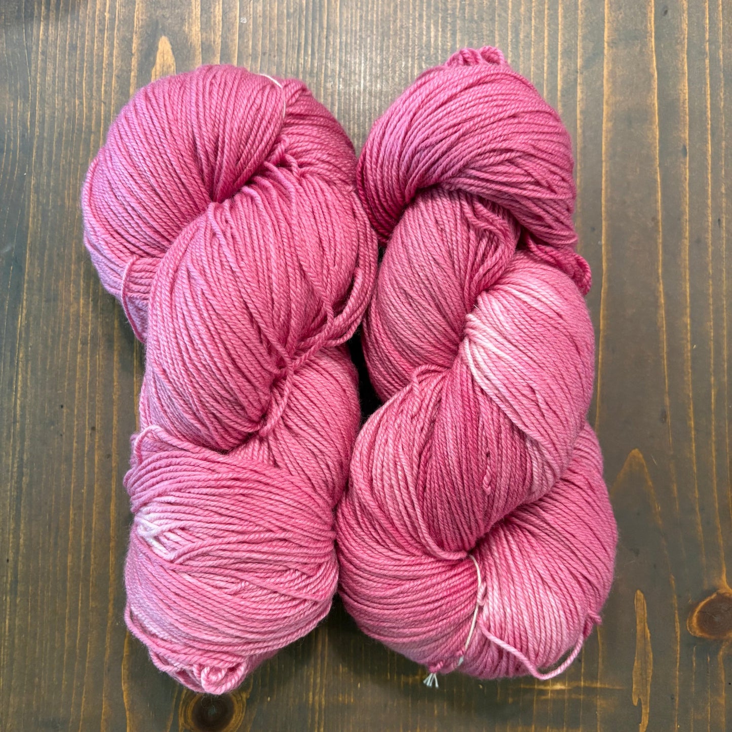 Hand dyed skein of Merino/silk blend yarn in a shade of pink